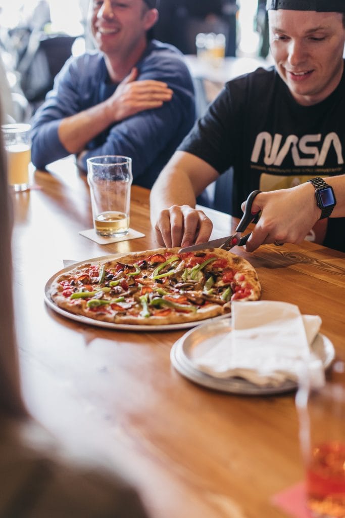 customers having pizza at red bird brewing