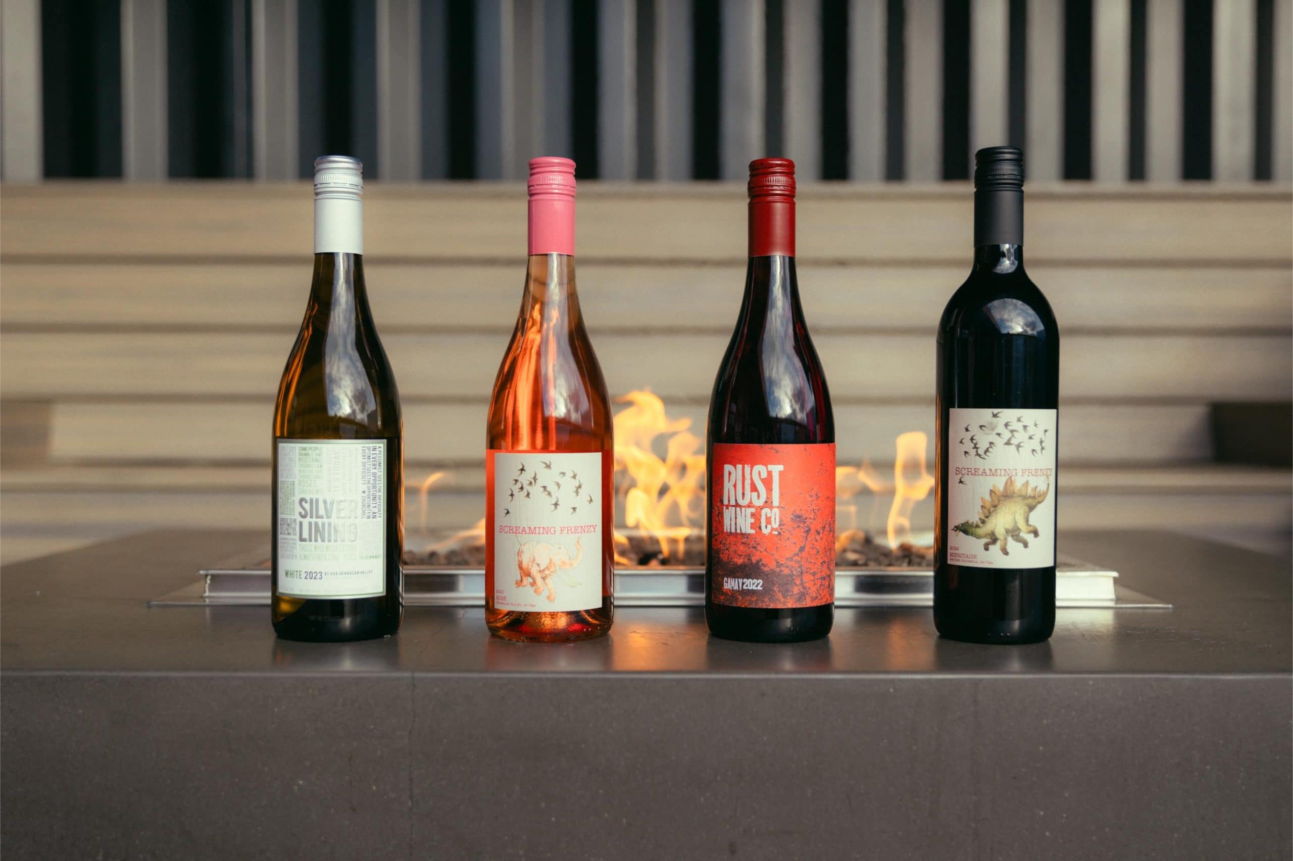 Wine bottles next to a fire pit seating at Red Bird Brewing Kelowna